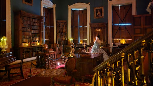 candles glowing in an ornate, high ceilinged room